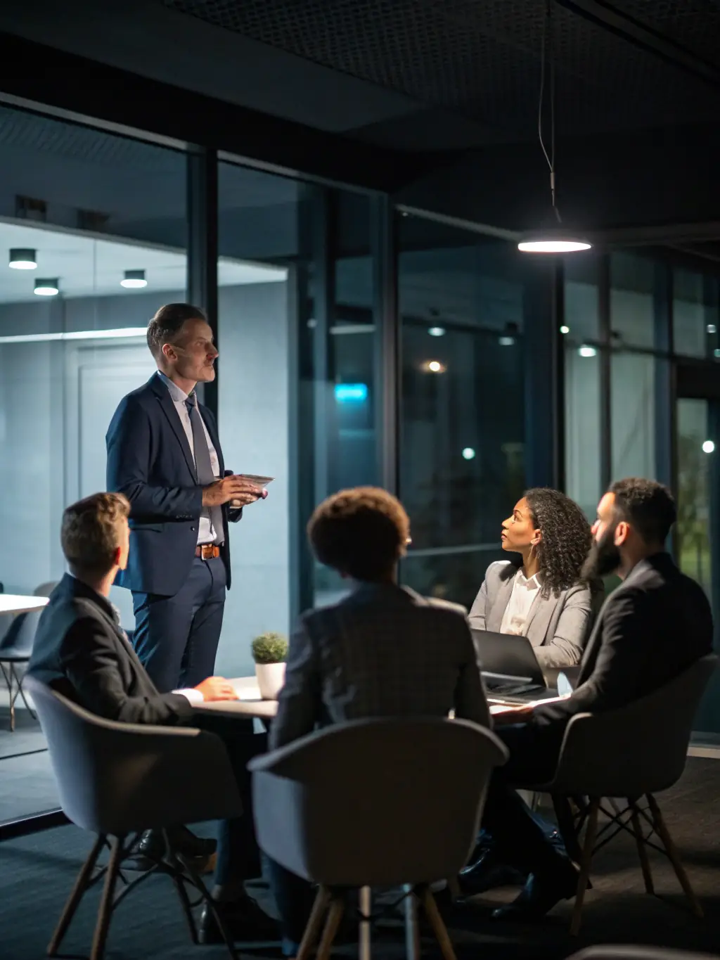 A professional photo of a diverse team of cybersecurity consultants in a modern office setting, reviewing compliance documents and discussing strategies for PDPL implementation, symbolizing expertise and collaboration.